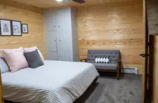 Rustic-style guest room with sturdy wood furniture and a charming Northwoods cabin feel.