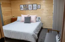 Serene bedroom setting with a view of the woods, perfect for birdwatching from bed.