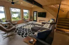 Modern open-concept living space at Smile Awhile featuring clean lines, hardwood floors, and high-speed Wi-Fi for a premium stay.