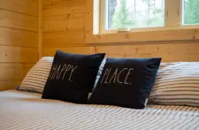 Bright and airy main bedroom with premium linens and modern decor for a restful lakefront stay.