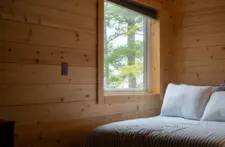 Master suite at our Eagle River vacation rental, showing a cozy atmosphere and large windows.