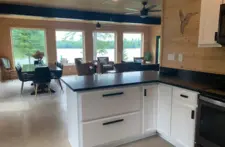 Sparkling clean kitchen with modern cabinetry and stylish backsplash at Smile Awhile lakefront property.