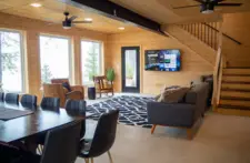 Spacious living room at Smile Awhile property, seamlessly connected to the dining area for easy entertaining and lakefront living.