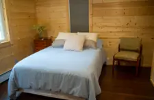 Detail of a well-appointed bedroom with fresh towels and a welcome feel for every guest.
