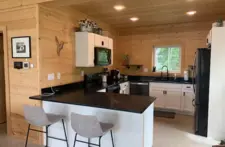 Bright kitchen area with natural light and views of the Eagle River woods, making cooking a relaxing experience.