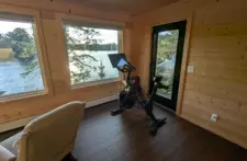 Private upstairs lounge with large windows, offering a quiet retreat and stunning Northwoods scenery in Eagle River.